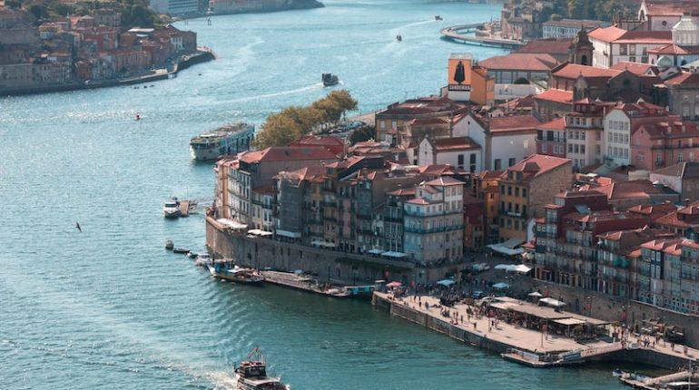 aerial view of city buildings beside body of water during daytime