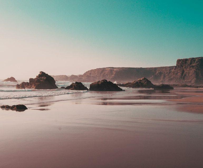 rock formations on seashore during daytime