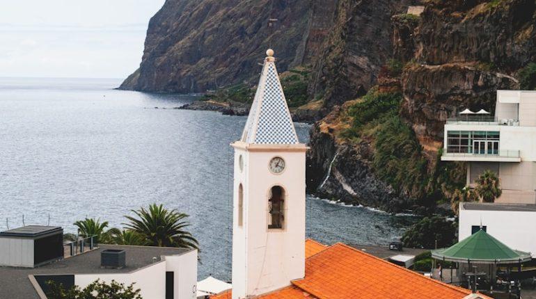 white and brown concrete building near body of water during daytime