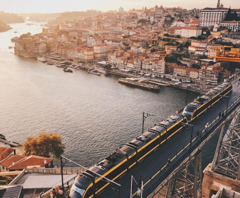 aerial view of city buildings near body of water during daytime